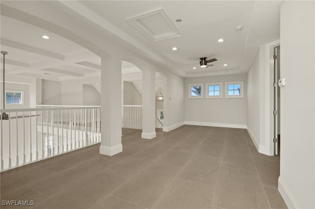 spare room featuring ceiling fan and plenty of natural light