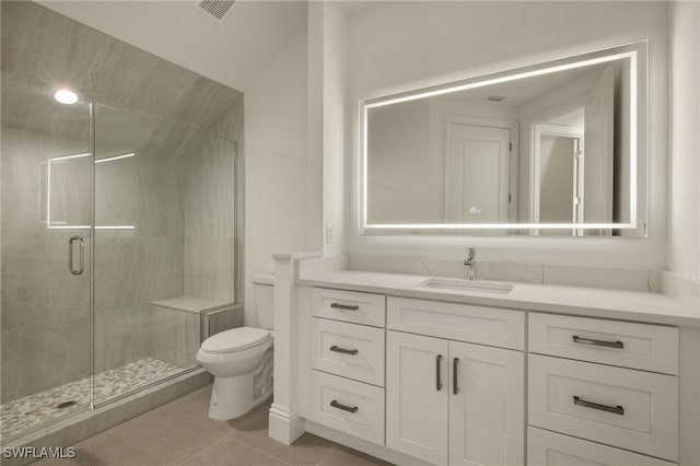 bathroom featuring a shower with door, tile patterned flooring, vanity, and toilet