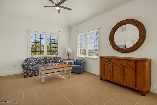 sitting room featuring vaulted ceiling, a wealth of natural light, light tile patterned floors, and ceiling fan