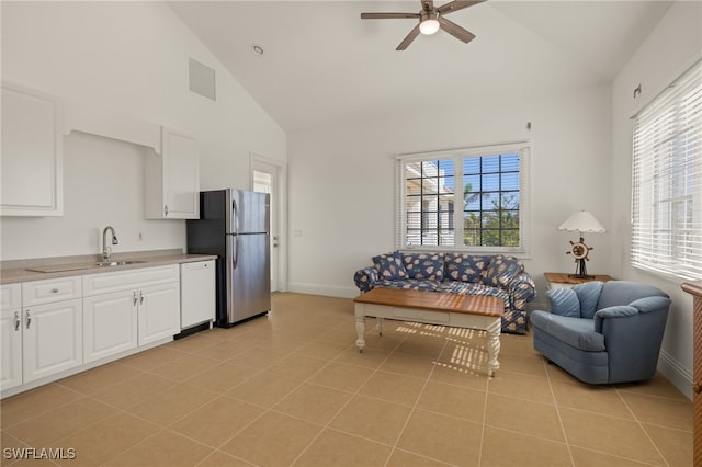 living room with a healthy amount of sunlight, ceiling fan, high vaulted ceiling, and light tile patterned flooring