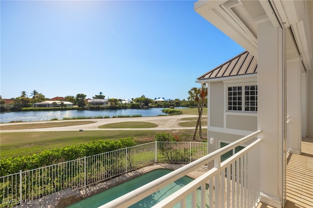 balcony with a hot tub and a water view