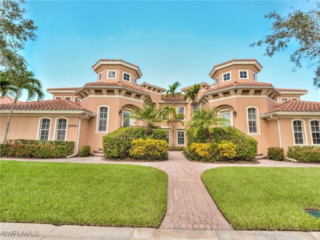 mediterranean / spanish house with a front yard