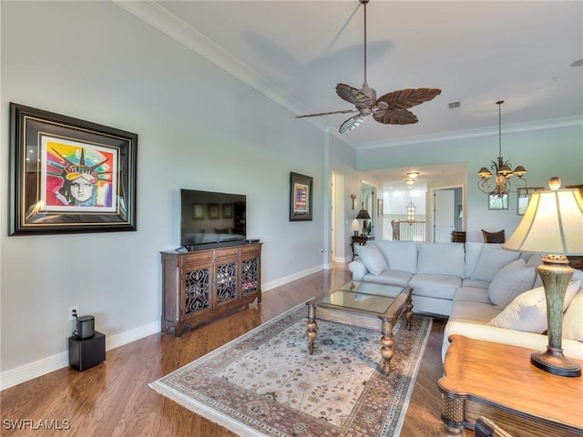 living room with ornamental molding, hardwood / wood-style floors, and ceiling fan with notable chandelier