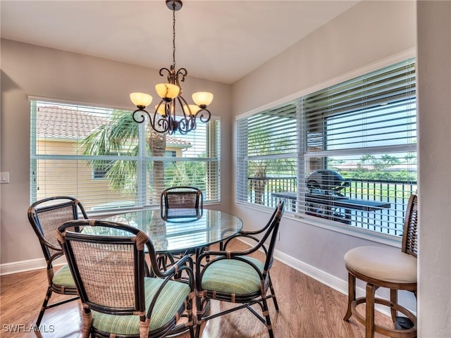 dining area featuring an inviting chandelier and light hardwood / wood-style floors