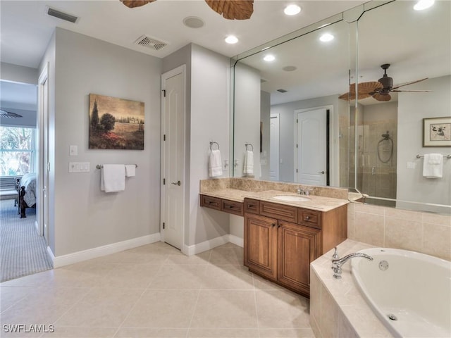 bathroom with tile patterned flooring, ceiling fan, plus walk in shower, and vanity