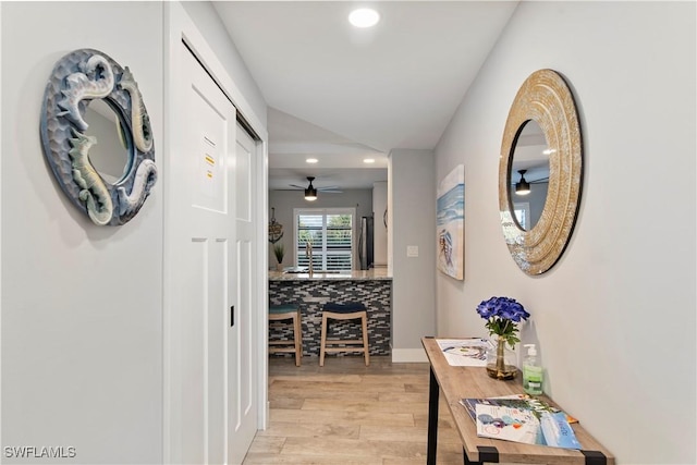 hallway with light hardwood / wood-style flooring