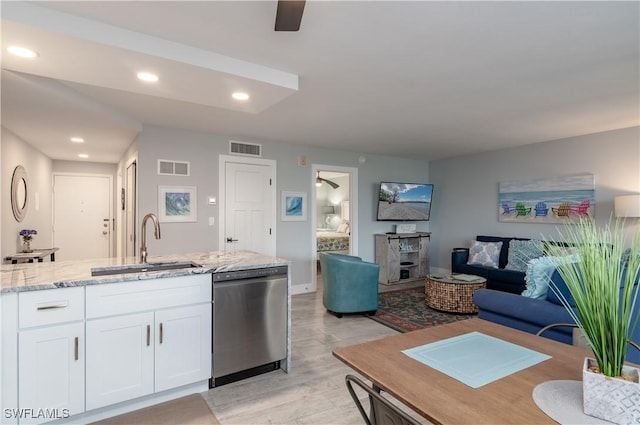 kitchen with dishwasher, light stone countertops, ceiling fan, white cabinets, and sink