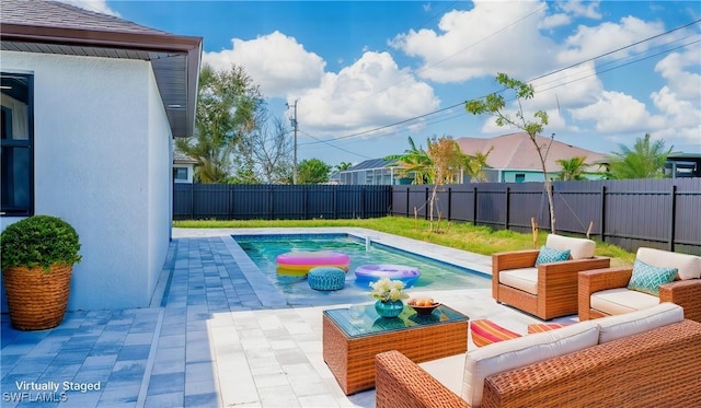 view of swimming pool with an outdoor living space and a patio