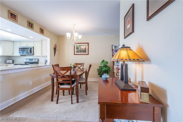 dining room featuring a chandelier and light hardwood / wood-style flooring