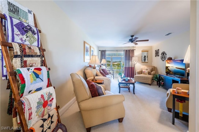 living room with ceiling fan and light colored carpet