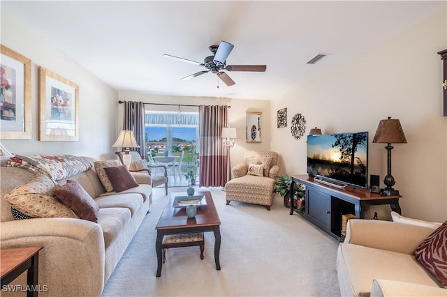 living room featuring ceiling fan and light colored carpet