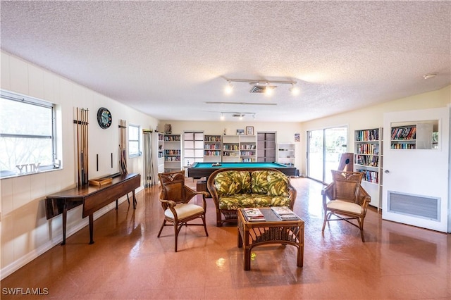 sitting room featuring a textured ceiling, billiards, and heating unit