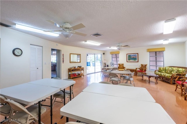 dining space featuring a textured ceiling and ceiling fan