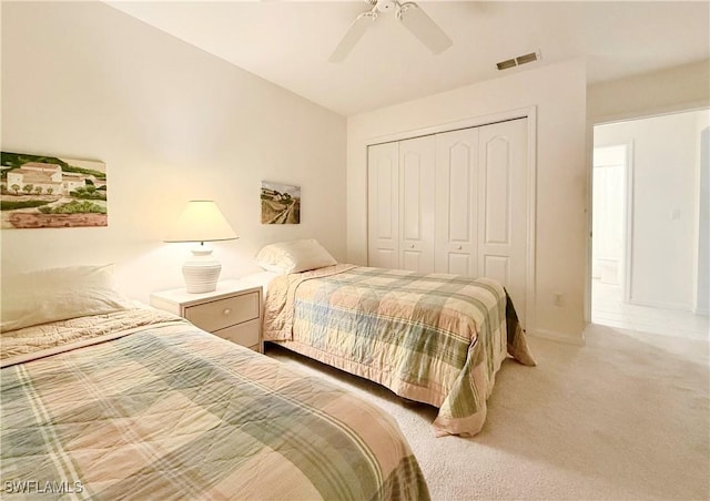 bedroom with a closet, ceiling fan, and carpet