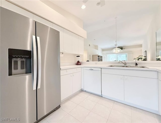 kitchen featuring white dishwasher, stainless steel fridge, ceiling fan, white cabinets, and sink