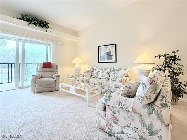 living room with lofted ceiling and carpet flooring