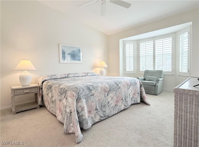 bedroom with lofted ceiling, ceiling fan, and carpet