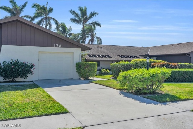 ranch-style home featuring a garage and a front yard