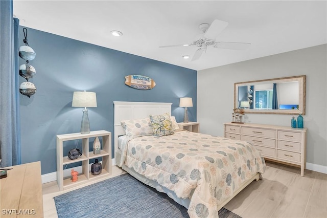 bedroom with light hardwood / wood-style flooring and ceiling fan