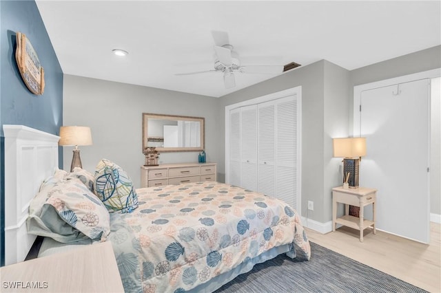 bedroom featuring light hardwood / wood-style floors, a closet, and ceiling fan