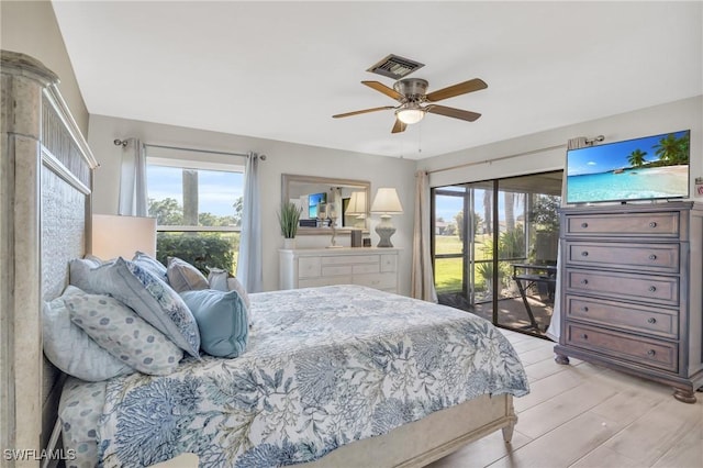 bedroom featuring ceiling fan, access to exterior, multiple windows, and light wood-type flooring