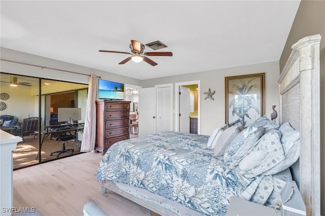 bedroom featuring ensuite bath, light hardwood / wood-style flooring, and ceiling fan