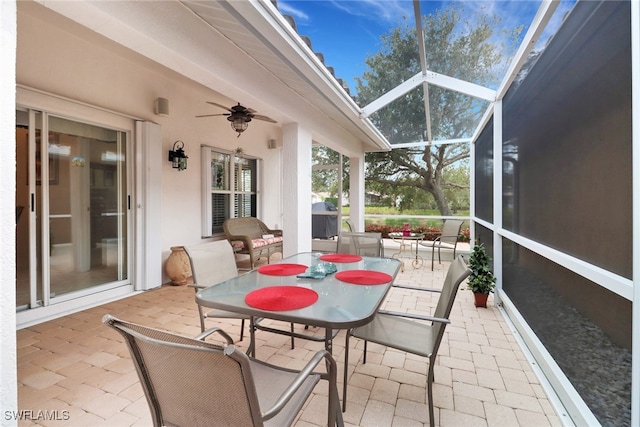 sunroom / solarium featuring ceiling fan