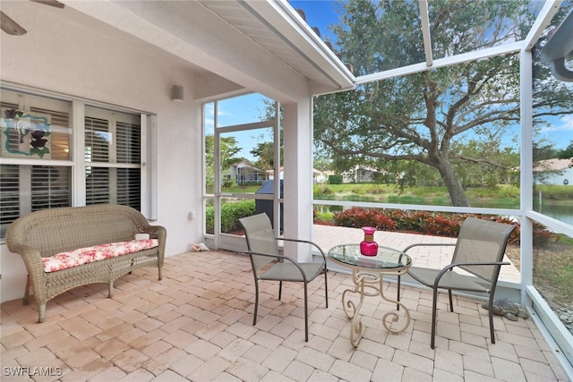 sunroom / solarium featuring ceiling fan