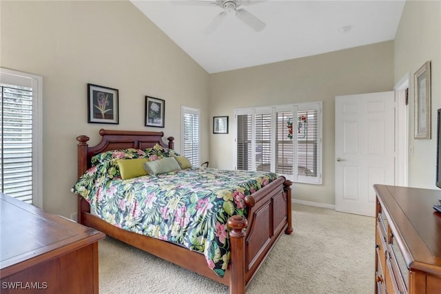 carpeted bedroom featuring ceiling fan, multiple windows, and lofted ceiling