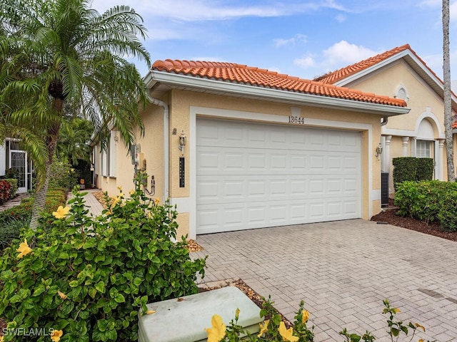 mediterranean / spanish-style home with a garage