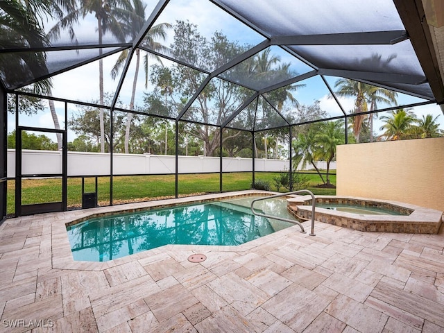 view of swimming pool with glass enclosure, a patio area, and an in ground hot tub