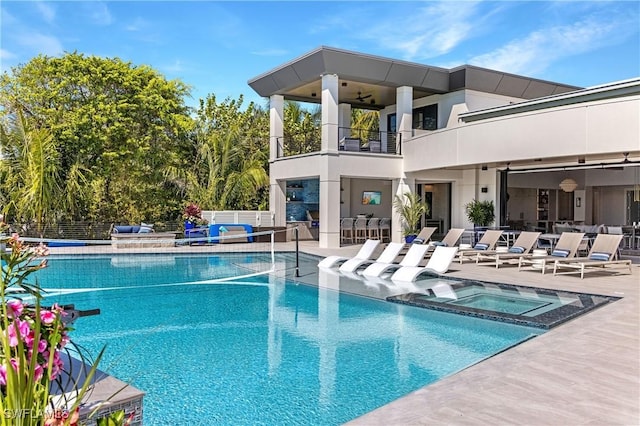 view of pool featuring a patio area and an in ground hot tub