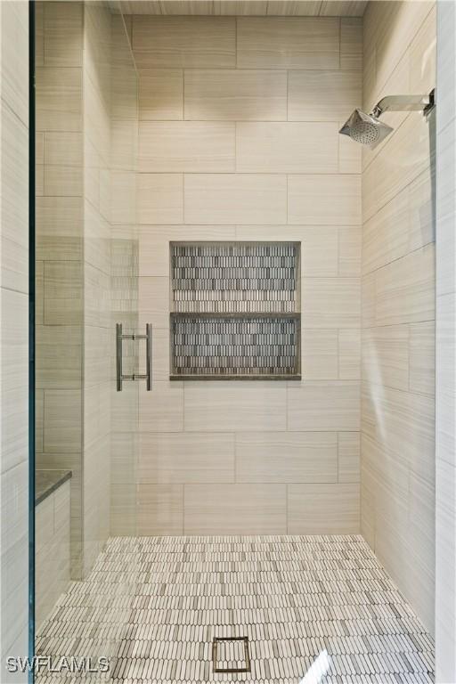 bathroom featuring a shower with door