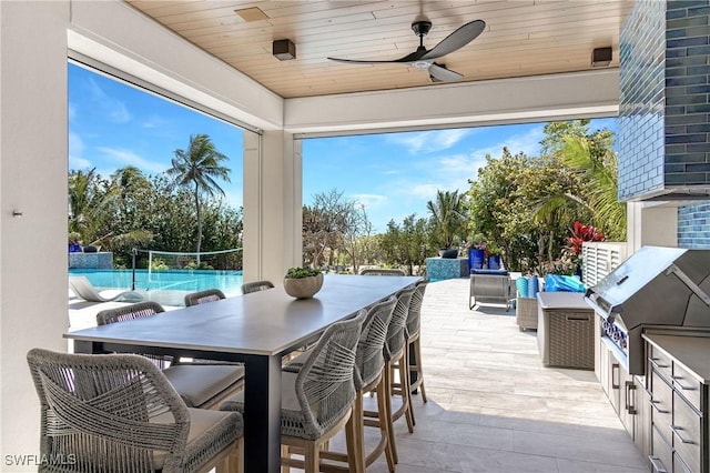 view of patio featuring ceiling fan, area for grilling, a grill, and an outdoor hangout area