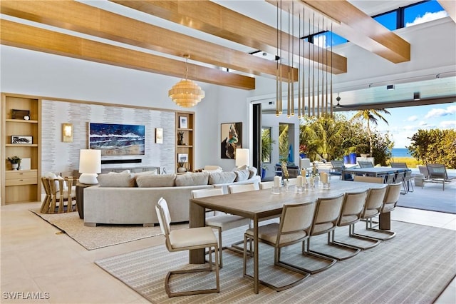 dining area with built in features, beam ceiling, and a chandelier