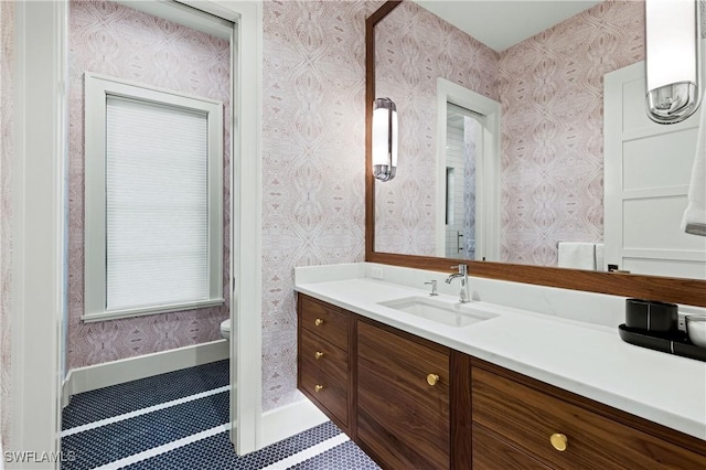 bathroom featuring toilet, tile patterned floors, and vanity