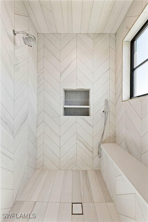 bathroom with tiled shower