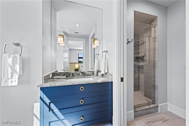 bathroom with a shower with shower door and vanity