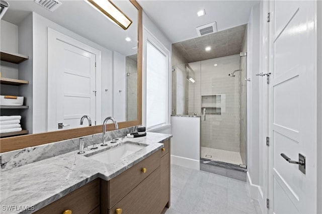 bathroom featuring an enclosed shower and vanity