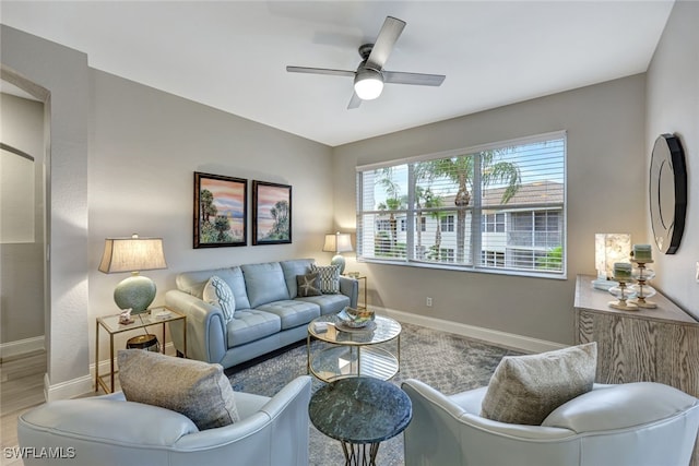 living room featuring ceiling fan and wood-type flooring