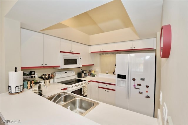 kitchen featuring white cabinets, sink, and white appliances