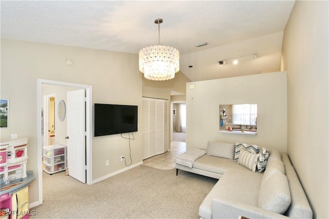 living room featuring light colored carpet, a textured ceiling, and a chandelier