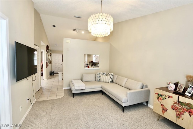 living room featuring light carpet and an inviting chandelier