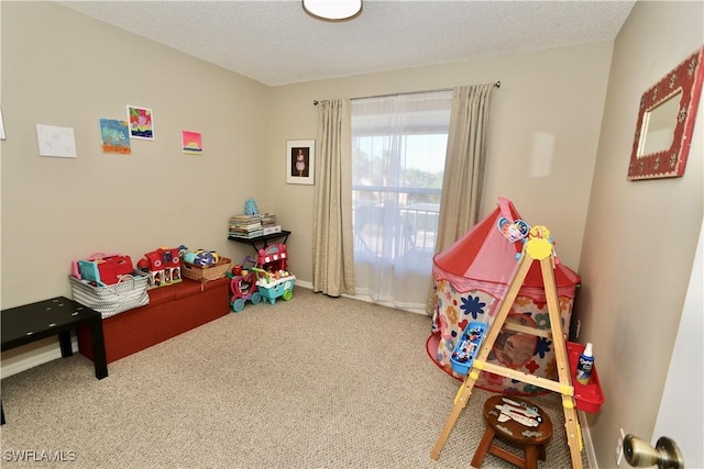 game room featuring a textured ceiling and carpet flooring