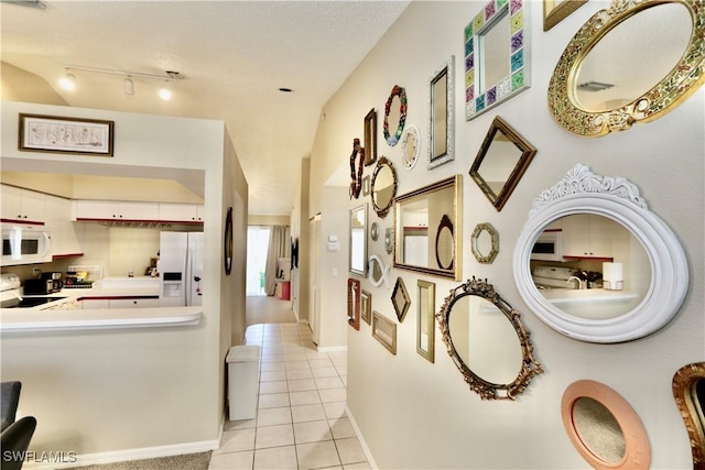 hall featuring light tile patterned flooring