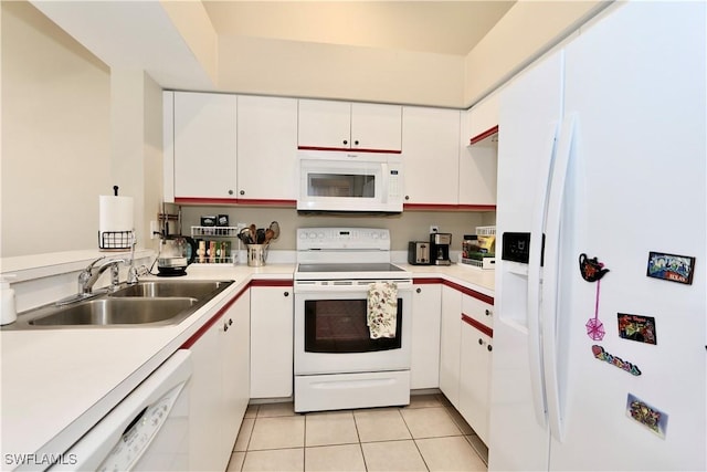 kitchen featuring white cabinetry, sink, white appliances, and light tile patterned floors