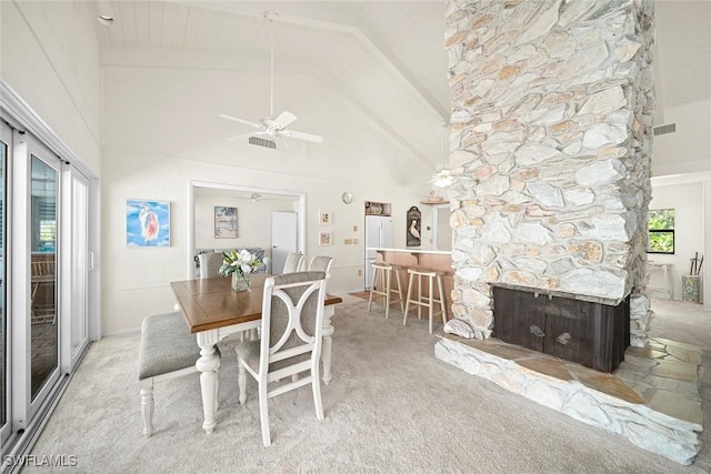 dining room with high vaulted ceiling, light carpet, and ceiling fan