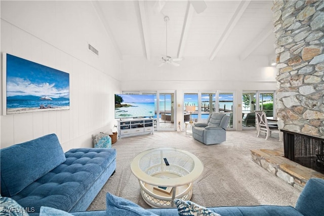 living room featuring high vaulted ceiling, a fireplace, light colored carpet, and beamed ceiling