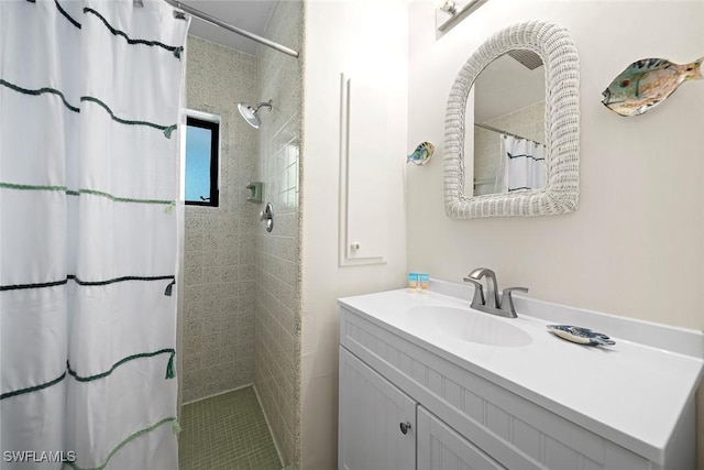 bathroom with walk in shower and vanity