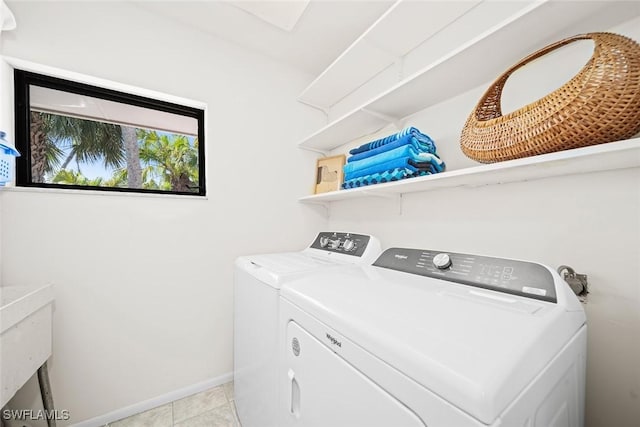 laundry room with light tile patterned floors and washing machine and clothes dryer